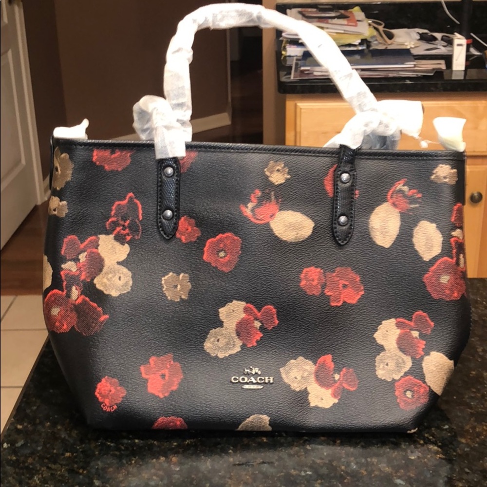 Over the shoulder, black coach purse.